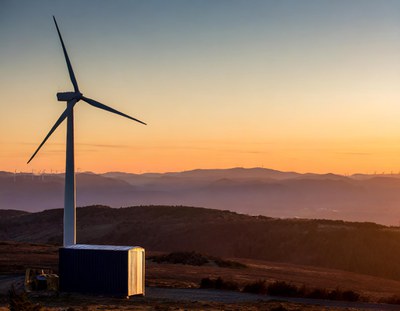 Firefly Lone wind turbine with a container close by in a vast landscape shining brightly in the deep.jpg